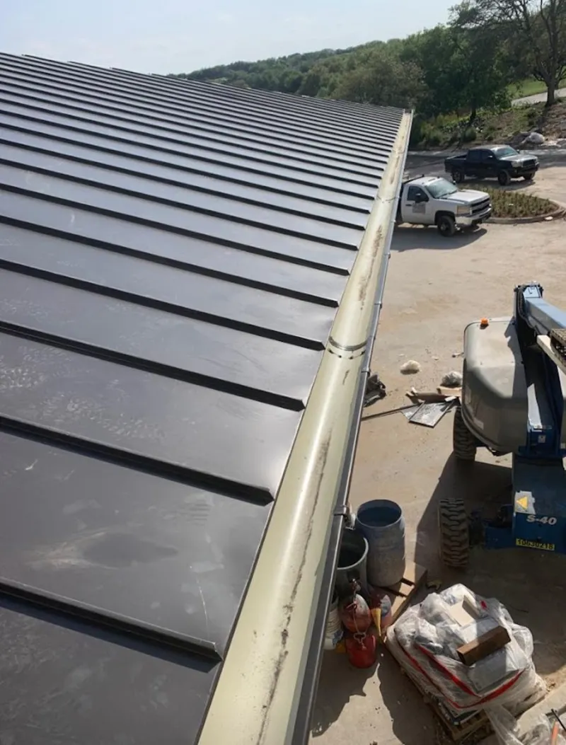 Standing seam panel and gutter detail on a metal roofing jobsite in Montgomery